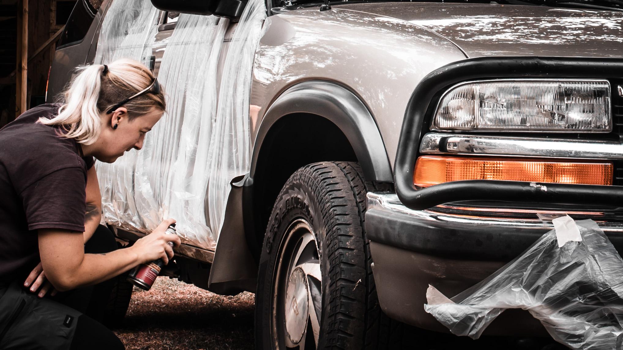 Anne fixing rust on her Chevy Blazer – solving real-world issues.