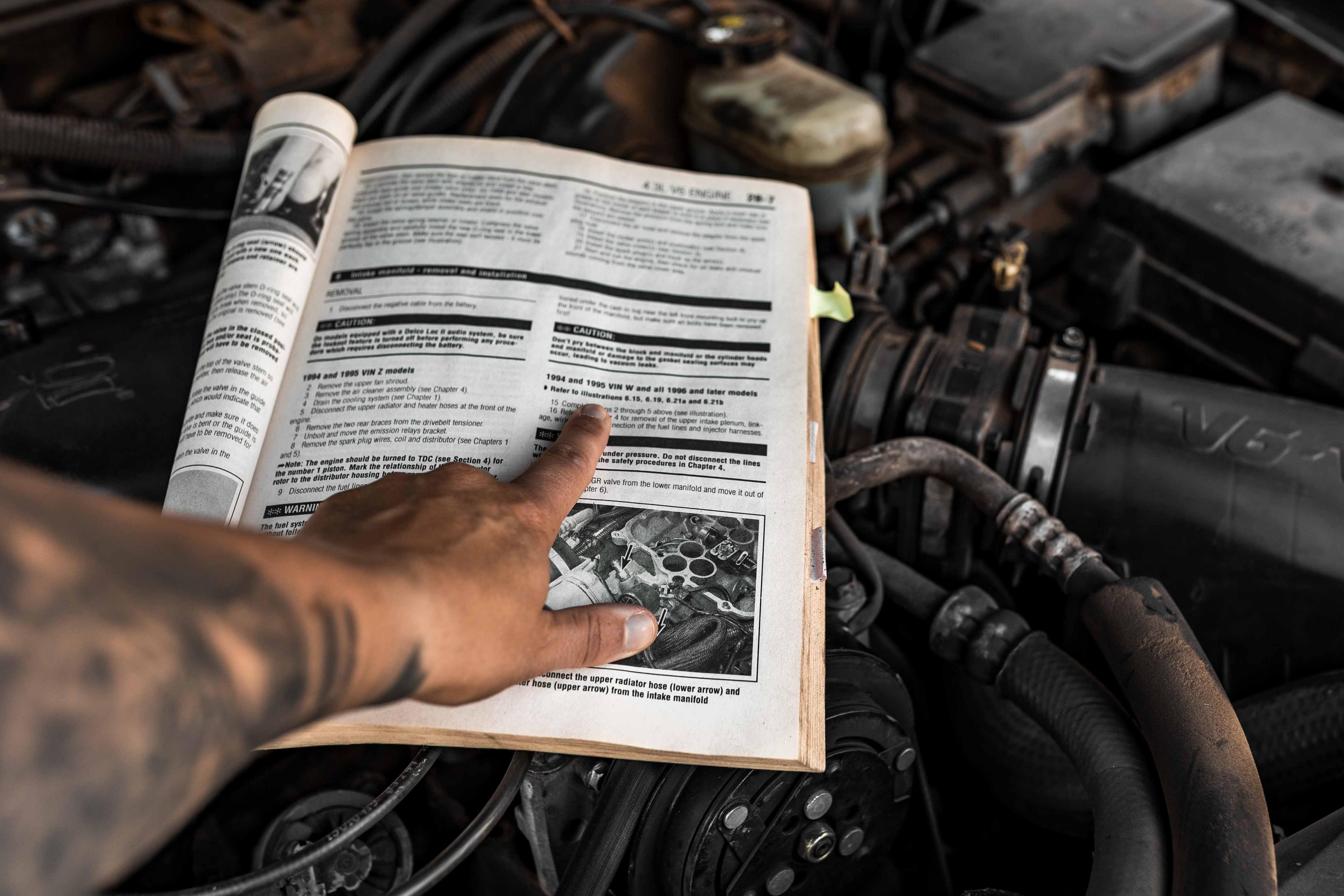 Close-up of the repair manual for an old Chevy Blazer, representing the idea of looking under the hood of an AppSec program to clarify ownership.