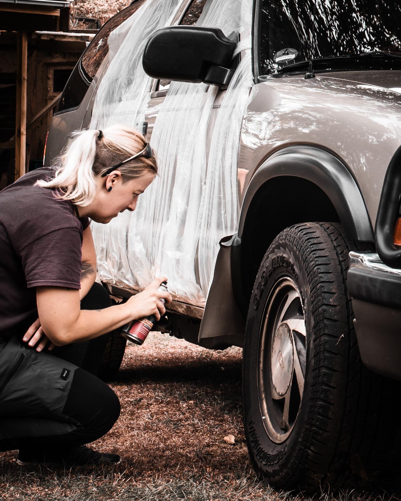 Anne working on her Chevy Blazer, representing how she learned to build AppSec programs by doing the work and getting my hands dirty.