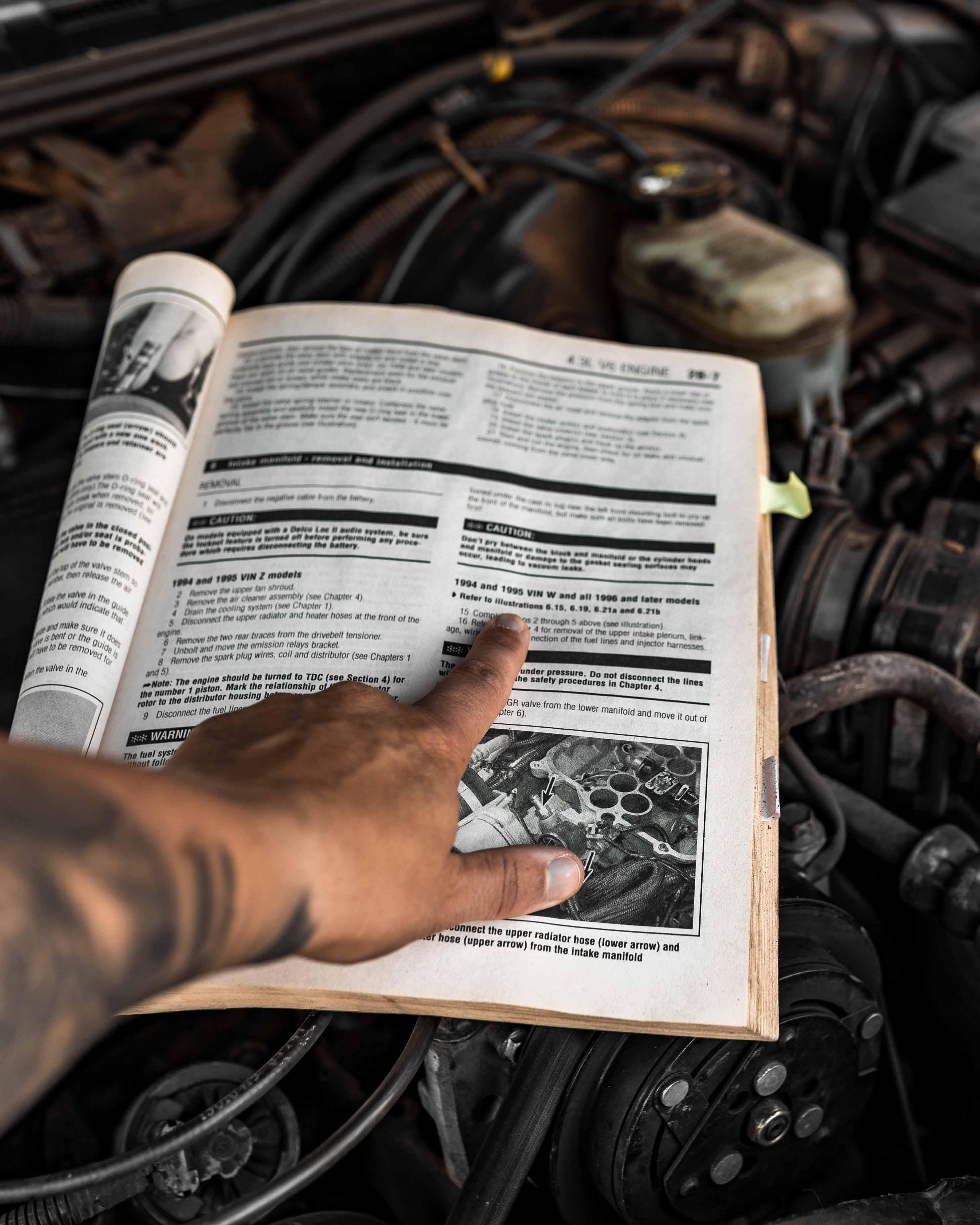 Close-up of the repair manual for an old Chevy Blazer, representing the idea of looking under the hood of an AppSec program to clarify ownership.