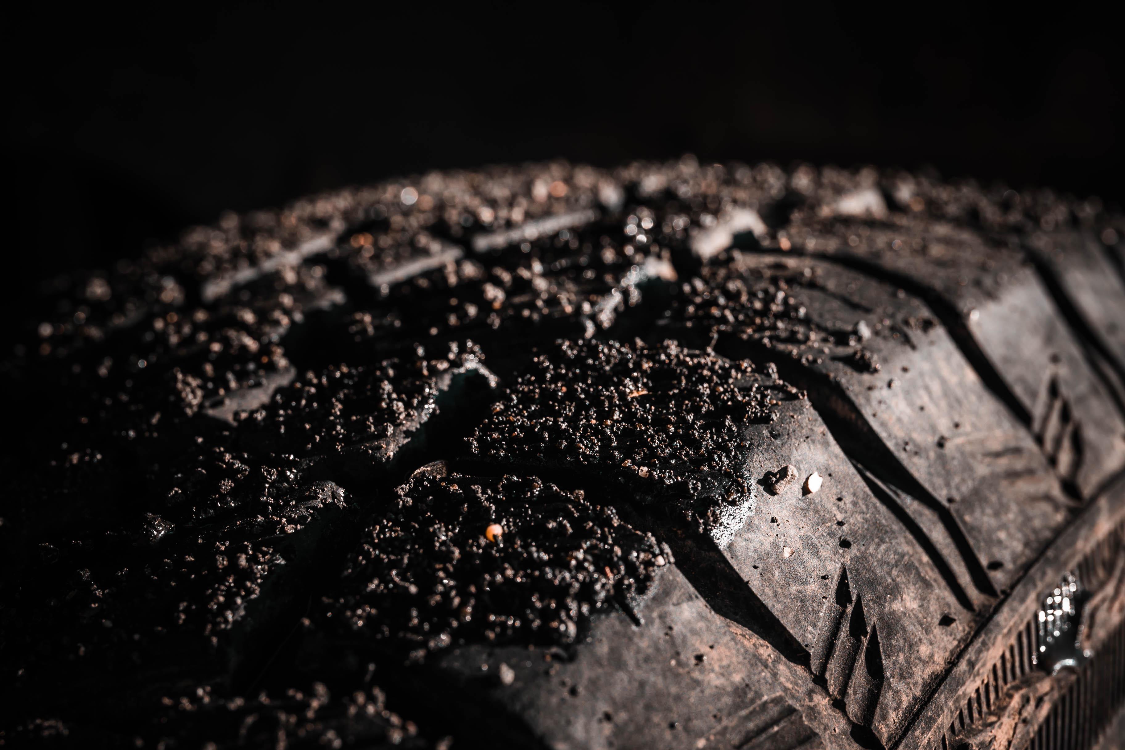 Close-up of a muddy off-road tire – because the right gear makes all the difference, in the wild and in security.
