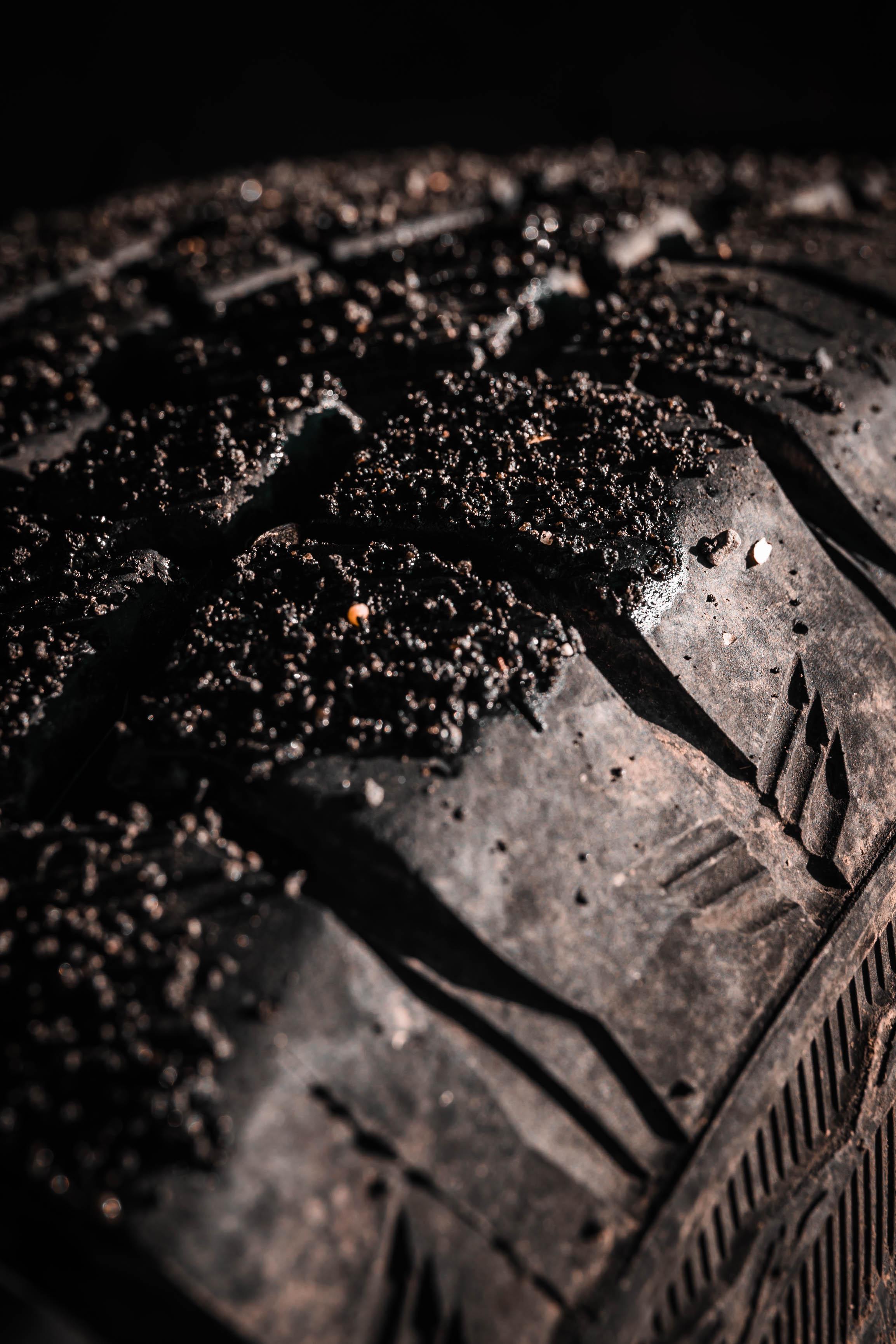 Close-up of a muddy off-road tire, representing the need to define AppSec ownership before moving forward through difficult terrain.