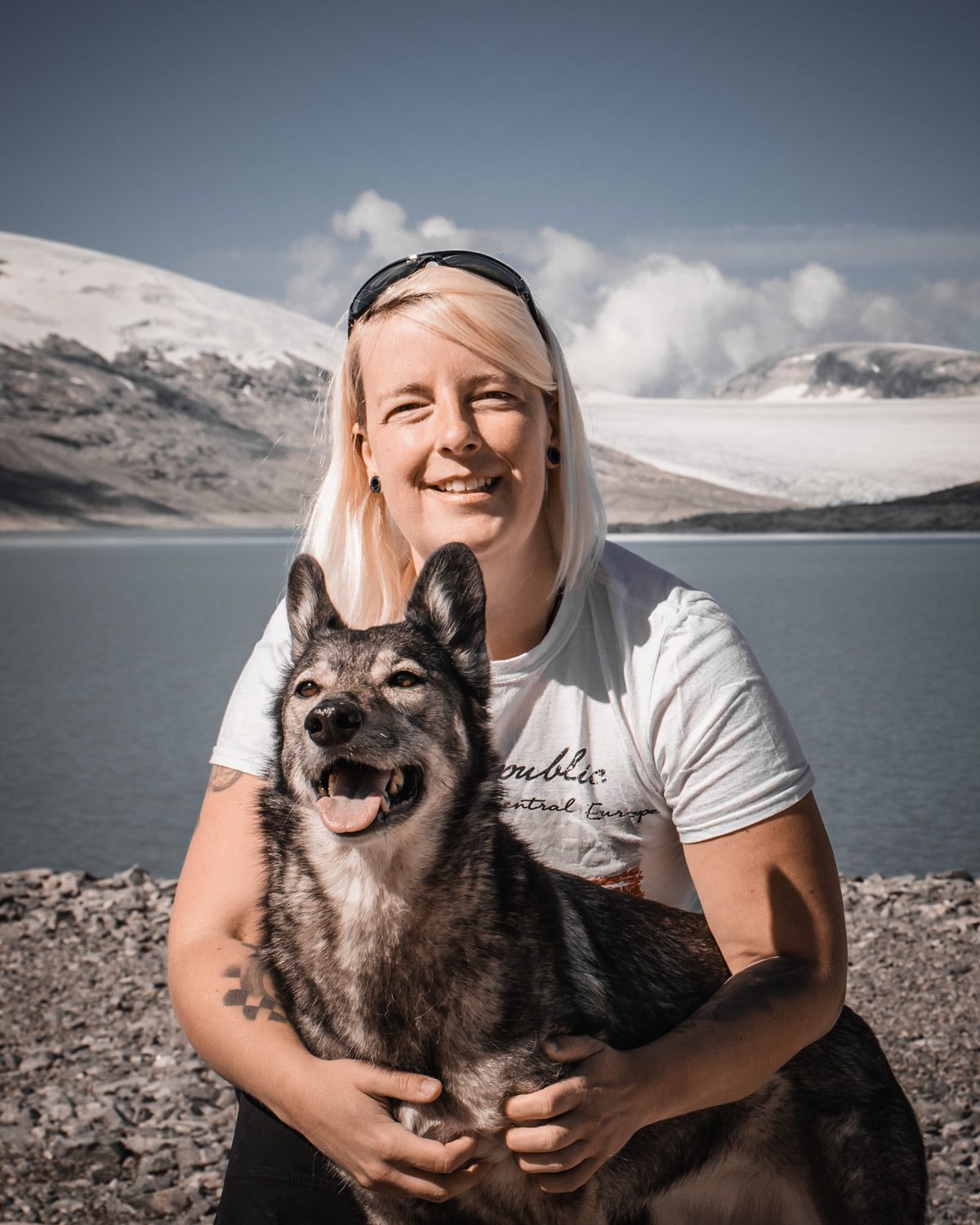 Anne with her dog on a glacier lake, Norway, representing experience with navigating real terrain and complex AppSec programs.