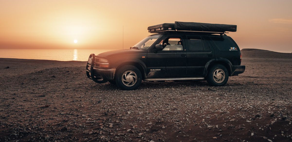 1999 Chevrolet S10 Blazer parked in the sand dunes at the Atlantic ocean in Morocco.