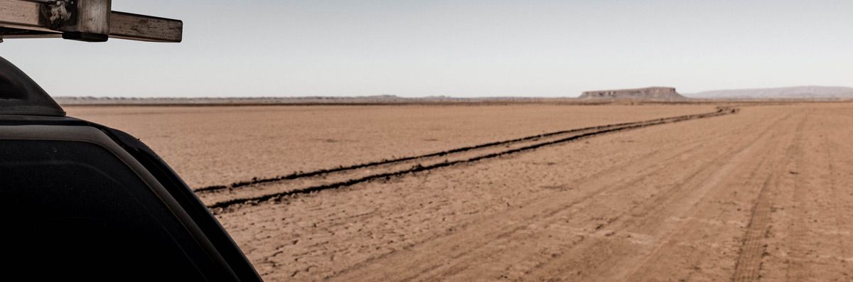 The track behind you View from beside Anne’s Chevy across the dry Lake Iriki in Morocco, showing the off-road track already traveled.