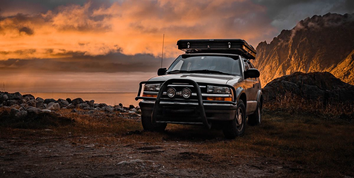 AppSec taken offroad – beyond the paved-road illusion Chevy Blazer on Senja, Norway at sunset — a visual metaphor for Application Security beyond the paved-road illusion and into the rough terrain of reality.