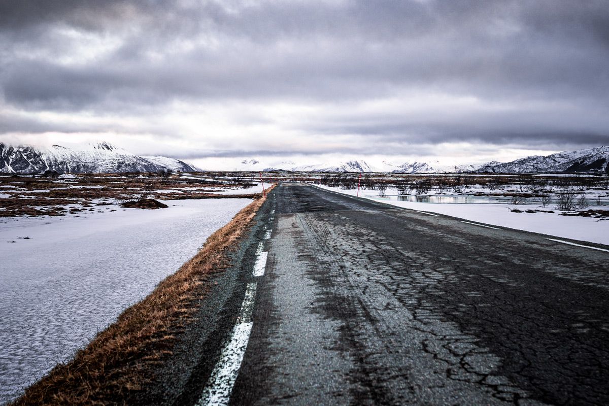 A paved road in northern Norway in winter. A paved road Anne did drive in northern Norway in winter representing the false assumption AppSec programs are built on.
