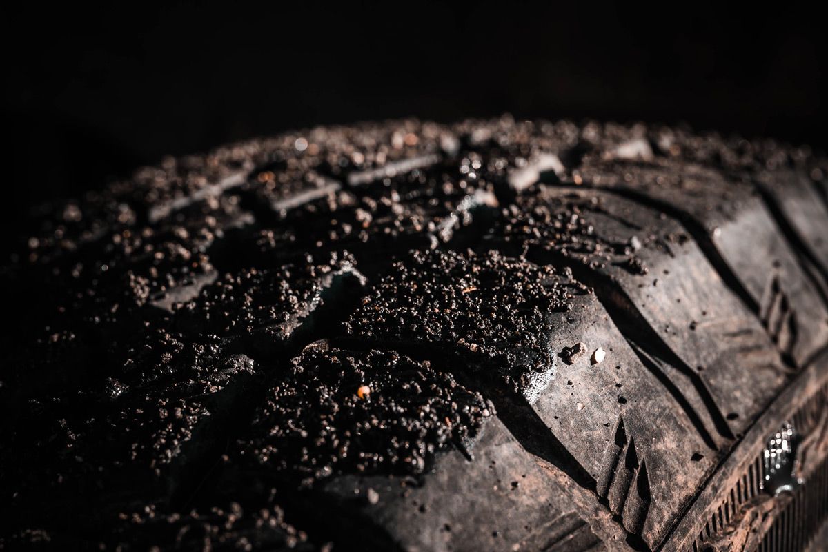 Defining the AppSec ownership vision Close-up of a muddy off-road tire, representing the need to define AppSec ownership before moving forward through difficult terrain.